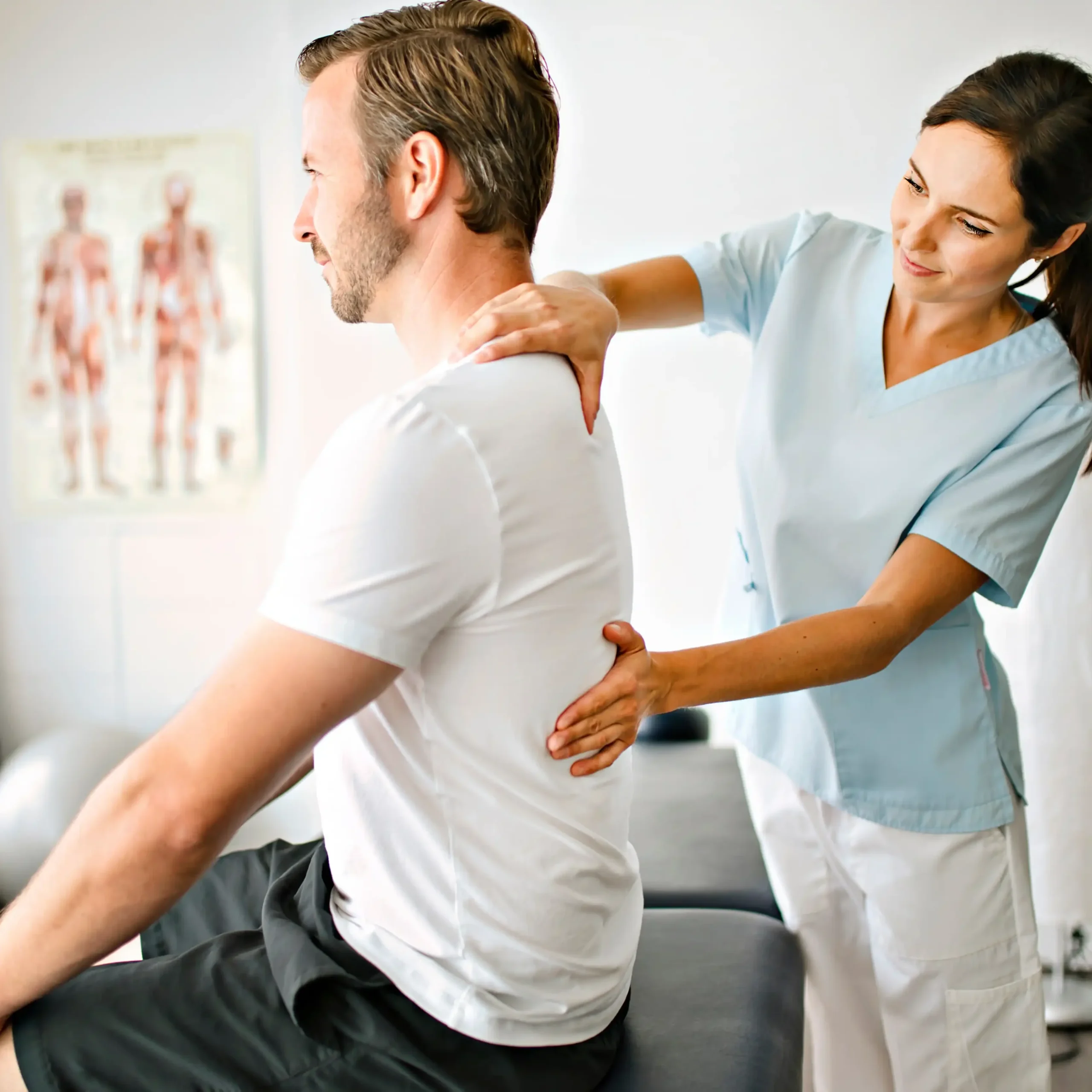 physical therapist evaluating her patient's back to figure out a treatment plan