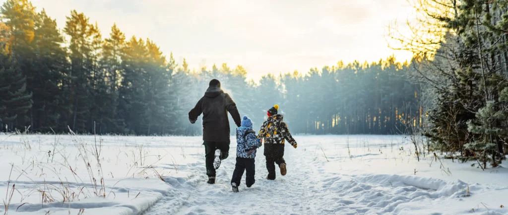 family playing together in the snow