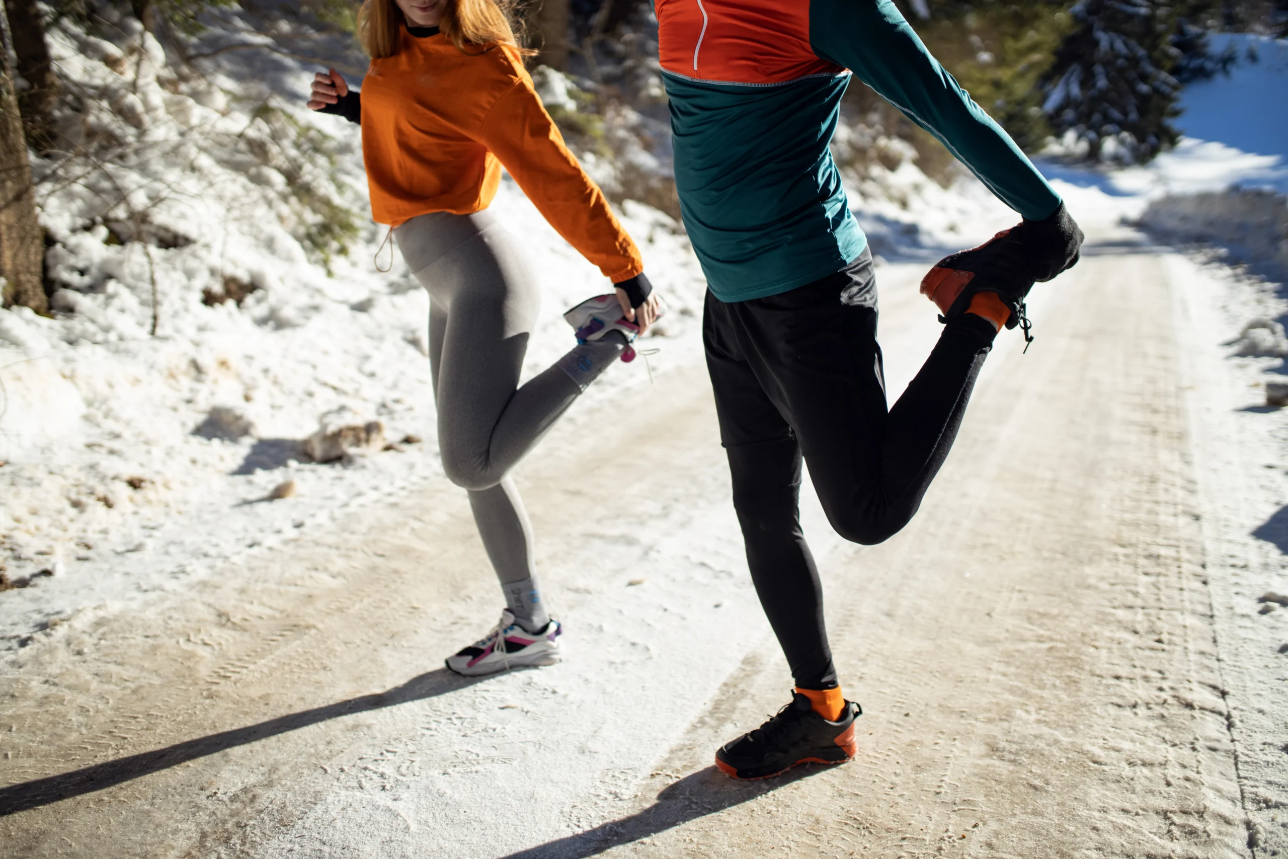 two athletes stretching their hamstrings before exercising